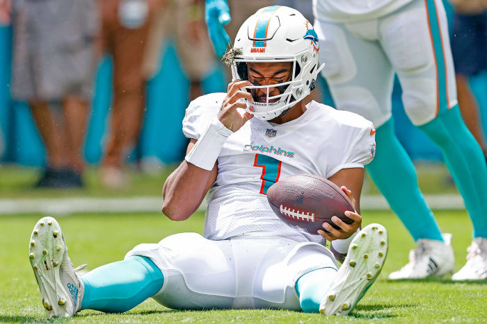 Tua Tagovailoa sits on the field after taking a sack.
